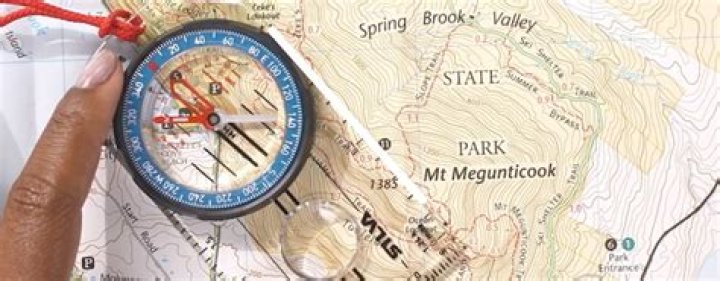 How do you find the direction of a compass on a topographic map?